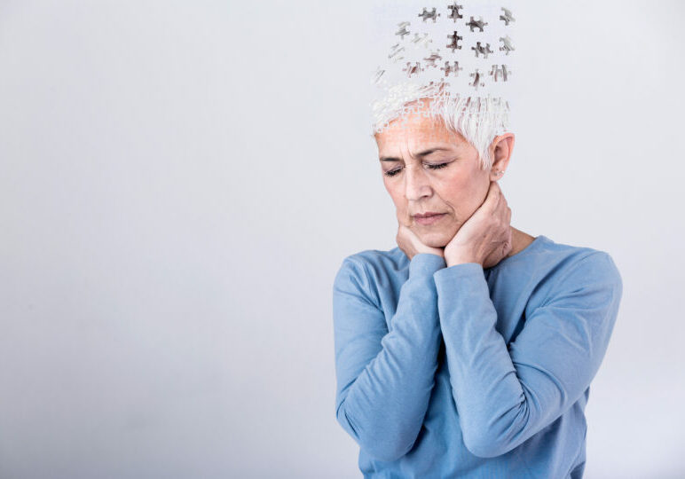 Memory Loss Due To Dementia. Senior Woman Losing Parts Of Head As Symbol Of Decreased Mind Function. Senior Woman Losing Parts Of Head Feeling Confused As Symbol Of Decreased Mind Function.
